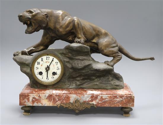 A spelter clock modelled as a tiger, on a marble base, signed T Cartier height 30cm